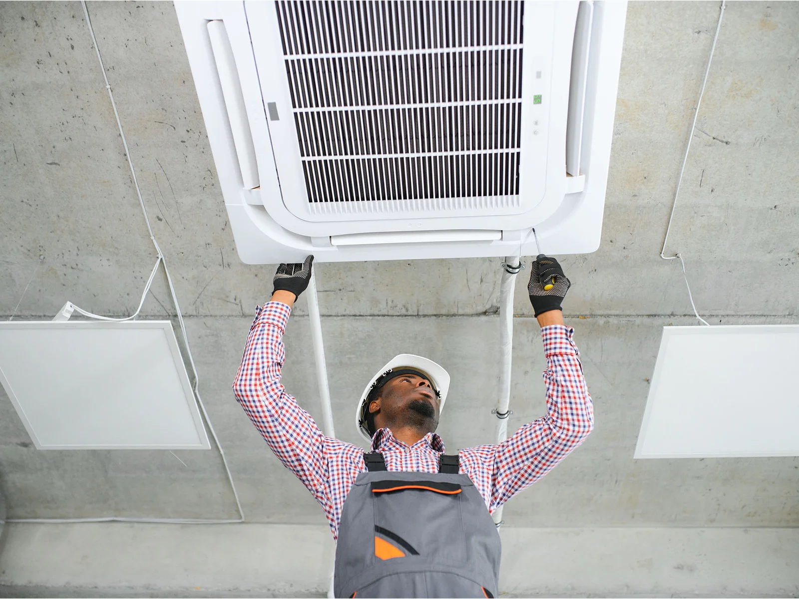 technician inspecting air con unit